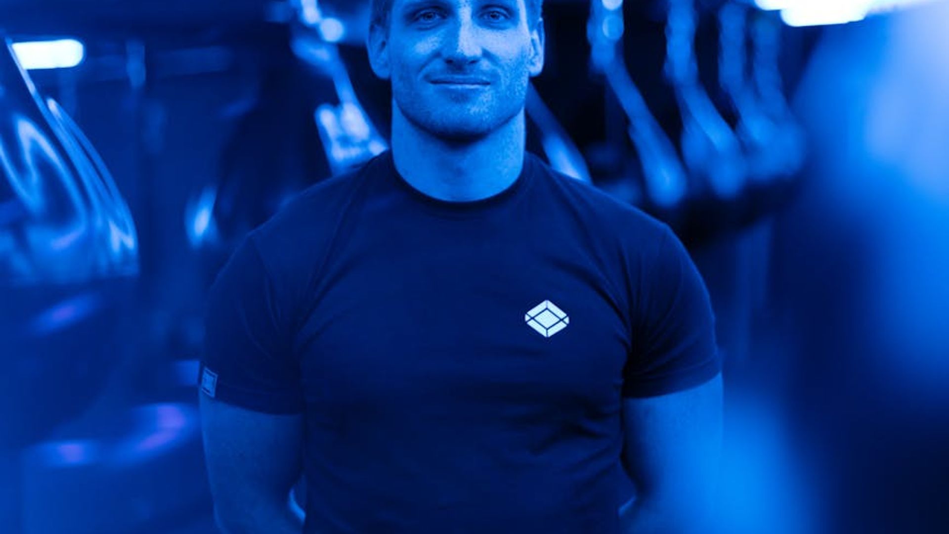 Active person moving in a dark neon lit gym