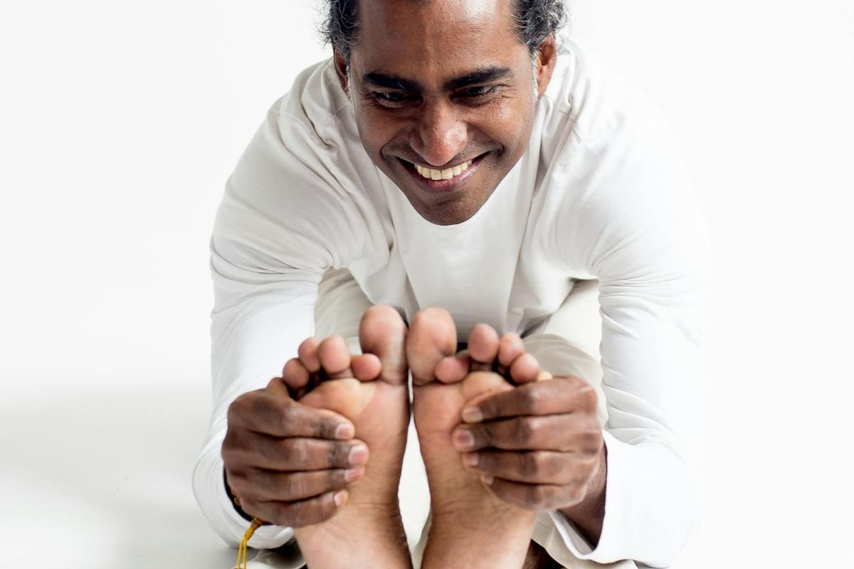 Person focusing on their breath in a dark minimalist room