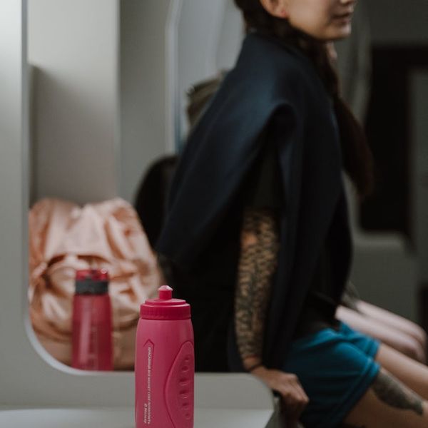 Water bottle on a bench in a dark gym